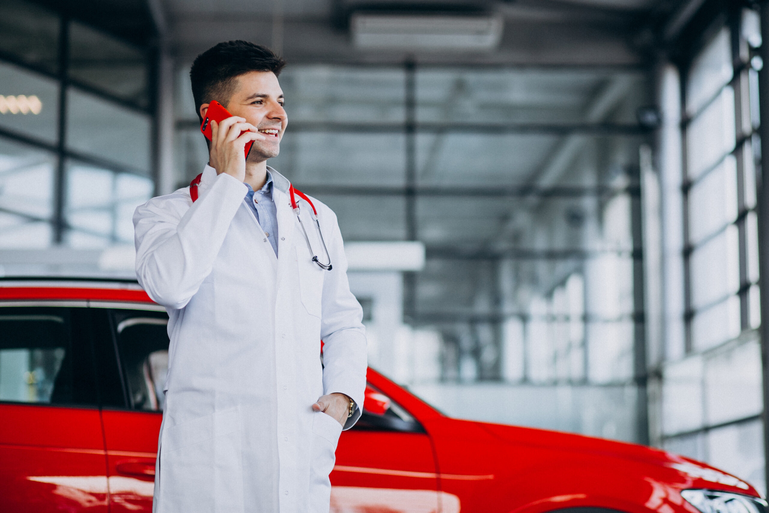 car technician with stethoscope car showroom talking phone scaled