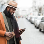 handsome man orange jacket posing outdoors with copy space