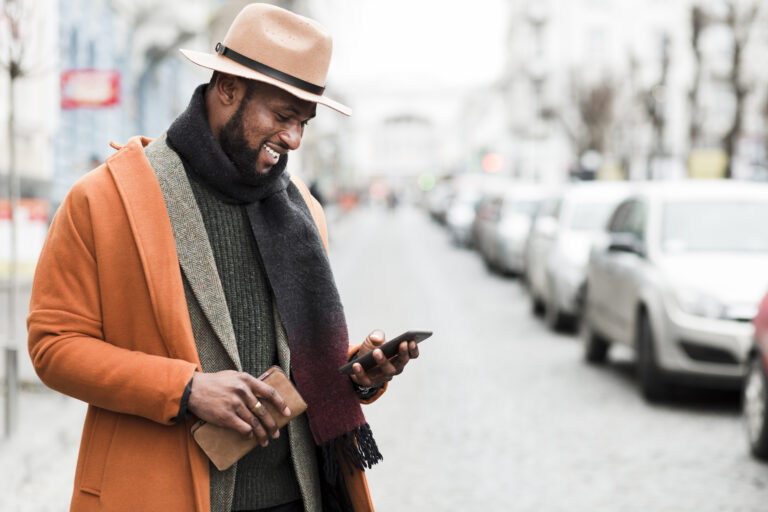 handsome man orange jacket posing outdoors with copy space