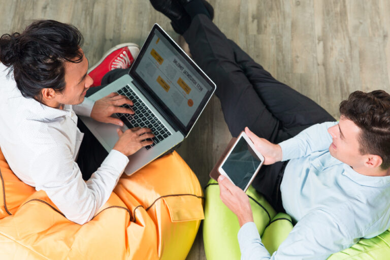 two business men working tablet laptop