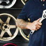 mechanic holding wrench